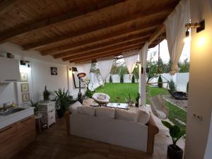 a living room with a couch and a table at The Green House - Jacuzzi & Garden Escape in Timişoara