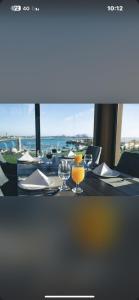 a table with wine glasses and a view of the ocean at Hoor Hotel in Jeddah