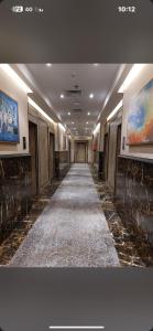 a hallway with a long aisle in a building at Hoor Hotel in Jeddah