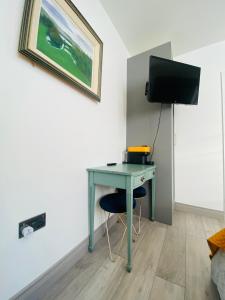 a room with a desk and a tv on a wall at CROKE PARK STUDIO in Dublin