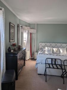 a bedroom with a bed and a dresser and a window at Sunny & Spacious Montclair NJ Apartment in Montclair