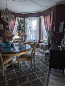 a dining room with a glass table and chairs at Sunny & Spacious Montclair NJ Apartment in Montclair