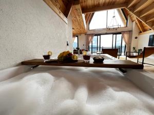 a large bath tub with a wooden table in a room at Meona Villa Bungalov in Ardeşen