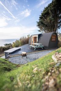 a black tiny house sitting on top of gravel at Sea View - Hot Tub, pet friendly in Barmouth