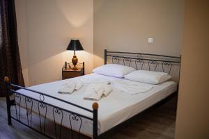 a bedroom with a bed with white pillows and a lamp at Villa Eridos in Káto Lekhónia +135 photos