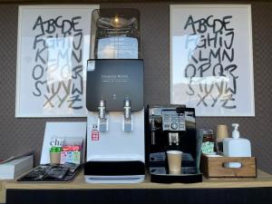 a coffee machine sitting on a table with a bottle of water at InnCocoSumu？ - Vacation STAY 03071v in Kirishima