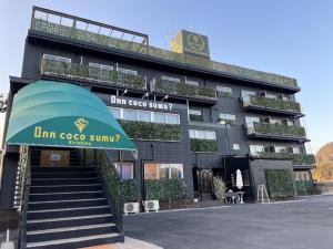 a building with an umbrella in front of it at InnCocoSumu？ - Vacation STAY 03071v in Kirishima