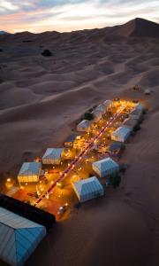 an aerial view of a desert at night at Luxury Sahara Camp in Merzouga