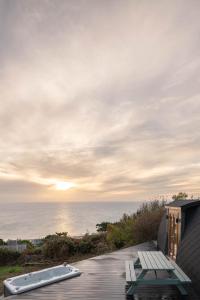 a view of the ocean from the deck of a house at Sea View - Hot Tub, pet friendly in Barmouth