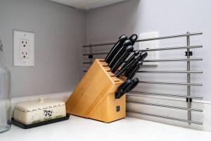 a knife block filled with knives sitting on a counter at Near YYZ and Yorkdale Mall w 2 Free Parking Spots in Toronto