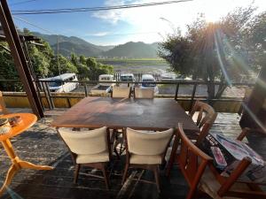 a wooden table and chairs on a patio with a view at Guest house HEART - Vacation STAY 04626v in Hitoyoshi
