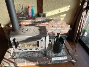 a brick fireplace with a stove in a room at Guest house HEART - Vacation STAY 04626v in Hitoyoshi