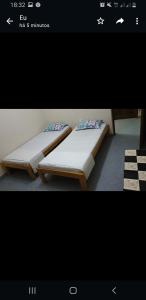 two beds sitting next to each other in a room at Residencial/ Pensão Natur in Tarrafal