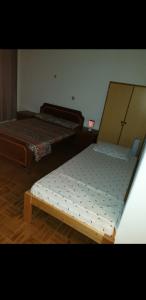 two beds sitting in a room with at Residencial/ Pensão Natur in Tarrafal