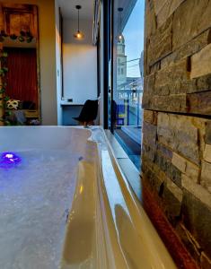 a pool of water next to a brick wall at Habitación Deluxe 1 con Jacuzzi a 20mt del parque in Salento +22 photos