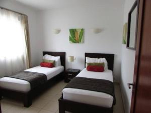 a hotel room with two beds and a window at Peaceful Paradise at Tortuga Beach - 473 in Prainha