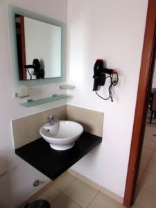 a bathroom with a sink and a mirror at Peaceful Paradise at Tortuga Beach - 473 in Prainha