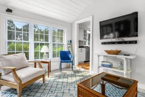 a living room with a tv and a couch and a table at 19 Burton Avenue West Harwich - - Lobsta House in West Harwich