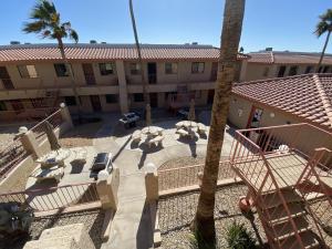 un edificio con cortile con tavoli e palma di Pasado Del Rio, Downtown getaway a Lake Havasu City