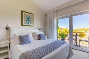 a bedroom with a bed and a balcony at Abracadabra Pousada in Búzios