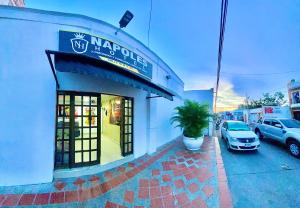 a store front with a potted plant in front of it at Hotel Napoles Valledupar in Valledupar