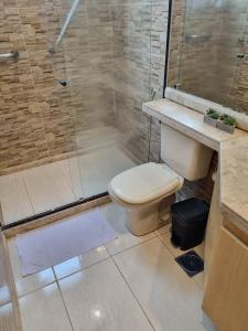 a bathroom with a toilet and a shower at Flat Pancetti in Belo Horizonte
