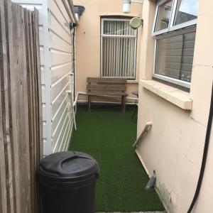 a patio with a bench and green grass at Kings Lynn 1 in King's Lynn