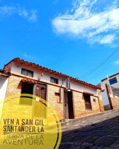 a building with a yellow sign on the side of it at SANTANDER ALEMAN HOSTEL in San Gil
