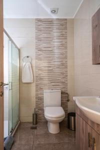 a bathroom with a toilet and a sink at NEON Apartment, modern, high quality, central Apt, Heraklion City in Heraklio