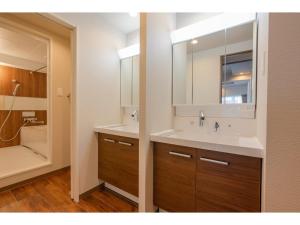 a bathroom with two sinks and a large mirror at VILLA KOSHIDO KOTONI - Vacation STAY 49616v in Sapporo