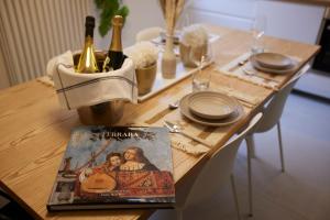 a table with bottles of champagne and a magazine at LikeHome San Romano -3Rooms - 10persone -Ferrara in Ferrara