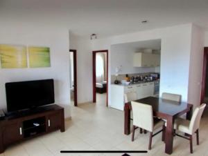 a living room with a dining table and a kitchen at Peaceful Paradise at Tortuga Beach - 473 in Prainha