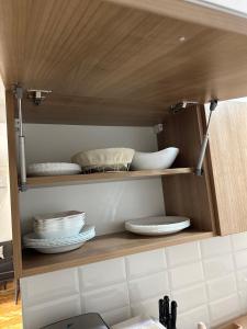 a cupboard with plates and dishes on it at Apartman 8 in Vrdnik