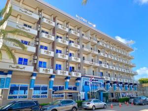 a large hotel with cars parked in front of it at Dolphin Ras El-Bar Hotel in Ras El Bar