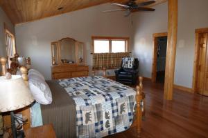 a bedroom with a bed and a ceiling fan at Mountain Maryland! Bear in the Woods in Grantsville