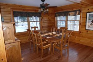 a dining room with a wooden table and chairs at Mountain Maryland! Bear in the Woods in Grantsville