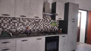 a kitchen with a sink and a stove at Casa Lombardo in Crotone