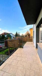 a balcony of a house with a fence at Beautiful rooms in Szczecin - parking Gratis in Szczecin