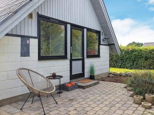 einen Stuhl auf einer Terrasse vor einem Haus in der Unterkunft Holiday home Karrebæksminde IX in Karrebæksminde
