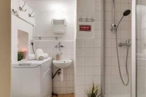 a bathroom with a toilet and a sink and a shower at Old Crooked Beams near Charles Bridge in Prague in Prague
