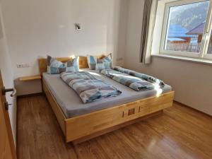a large bed in a room with a window at Ferienhaus Lena in Oetz