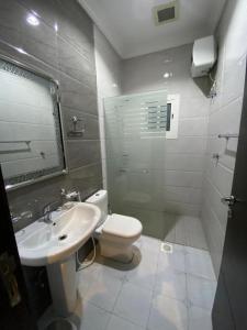 a bathroom with a toilet and a sink at فندق بيوتات المروة biutat almarwa in Jeddah