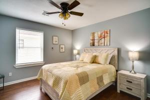 a bedroom with a bed with a ceiling fan at Lake Charles Home with Gas Grill and Fenced-In Yard! in Lake Charles