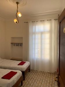 Postel nebo postele na pokoji v ubytování AFRIC HOTEL- Casbah