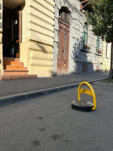 a yellow object sitting in the middle of a street at Central family apartment in Arad