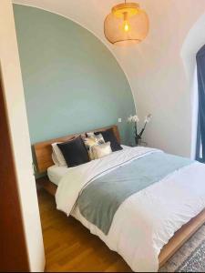 a bedroom with a bed with an arched ceiling at Penthouse 2 bedrooms With Terrace & Free Parking in Luxembourg