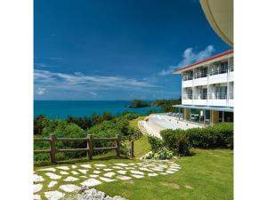 a view of a building with the ocean in the background at Hotel Hamahigashima Resort - Vacation STAY 10606v in Uruma