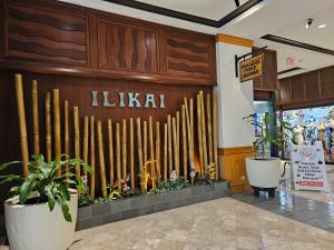 a store with a wall made out of wooden logs at Ilikai Tower 1533 Yacht Harbor View 1BR in Honolulu