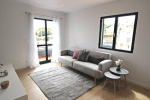 a living room with a couch and a table at Pedreira apartment in Calheta
