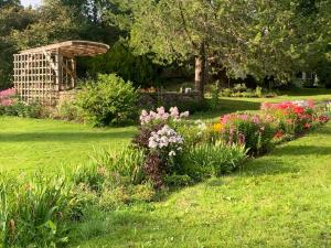 a garden with colorful flowers in the grass at Mokko Country Hotel in Palamuse